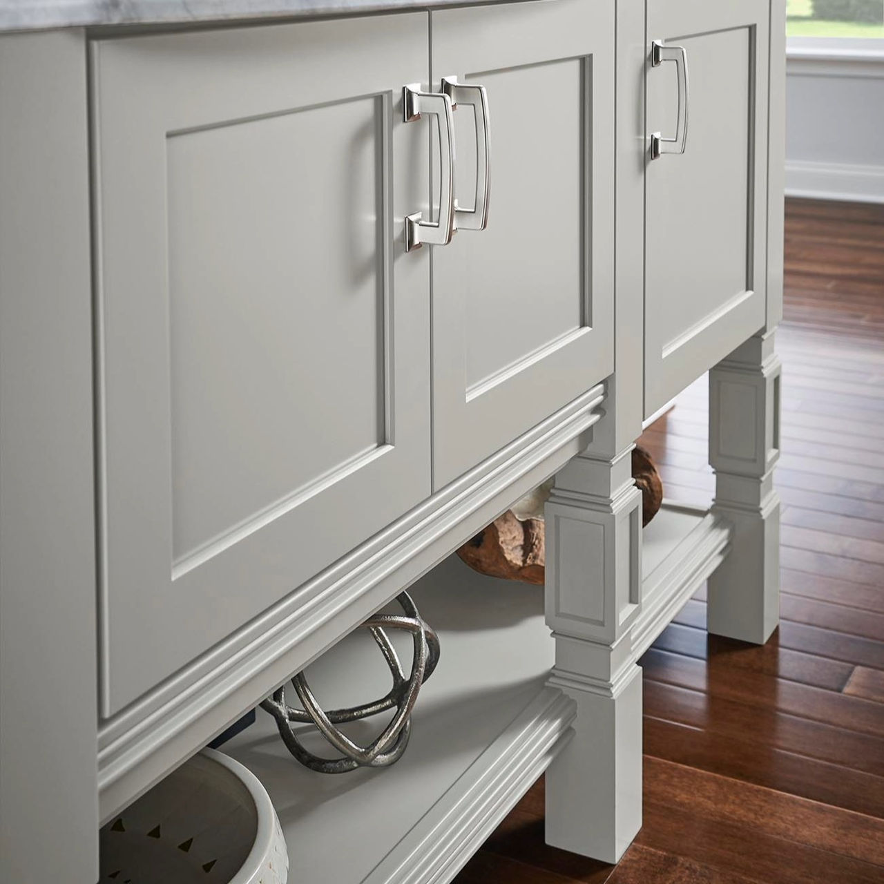 A kitchen island with a lower shelf and furniture legs